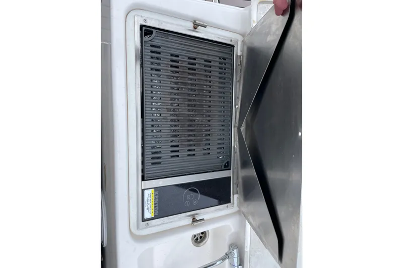 Slide: The Image of Built-in grill on 2024 Cutwater C-248 Coupe boat, featuring a sleek stainless steel cover. - 25