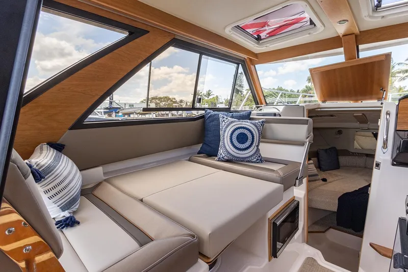 Slide: The Image of Manufacturer Provided Image: 2024 Cutwater C-248 Coupe interior with modern seating and decorative pillows. - 19