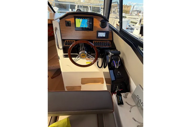 Slide: The Image of 2024 Cutwater C-248 Coupe helm with navigation display and controls. - 16