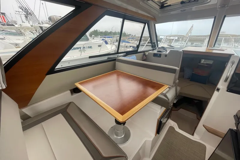 Slide: The Image of 2024 Cutwater C-248 Coupe interior with dining area and cabin view. - 12