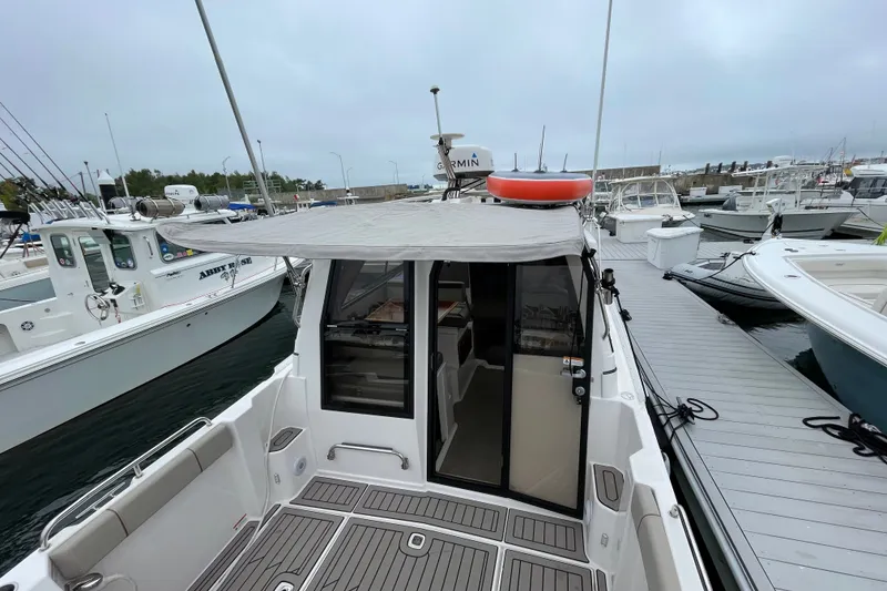 Slide: The Image of 2024 Cutwater C-248 Coupe docked at marina, showcasing rear deck and canopy. - 5