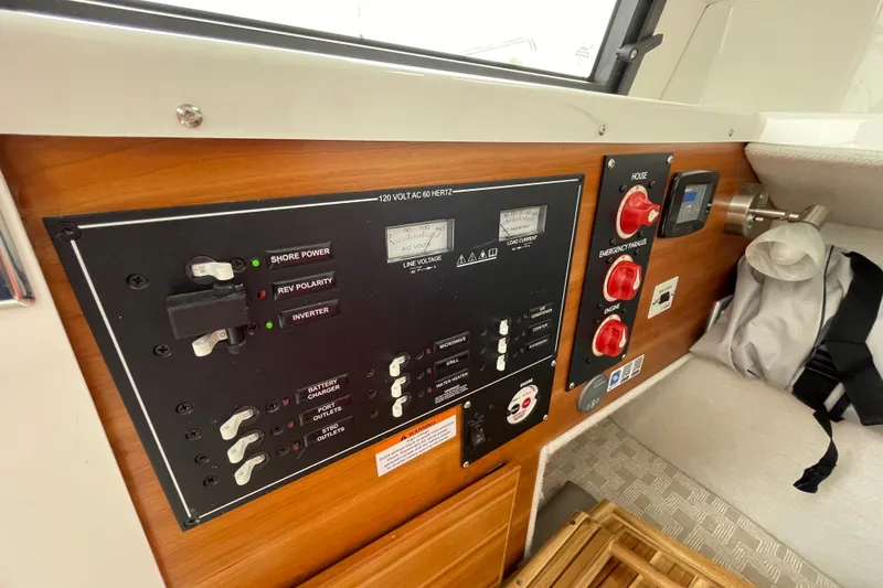Slide: The Image of 2024 Cutwater C-248 Coupe electrical control panel with switches and gauges. - 22