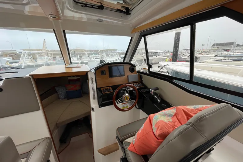 Slide: The Image of 2024 Cutwater C-248 Coupe interior with helm, seating, and cabin view. - 14