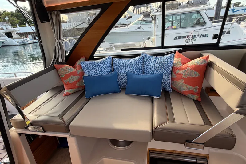 Slide: The Image of 2024 Cutwater C-248 Coupe interior with cushioned seating and decorative pillows. - 24
