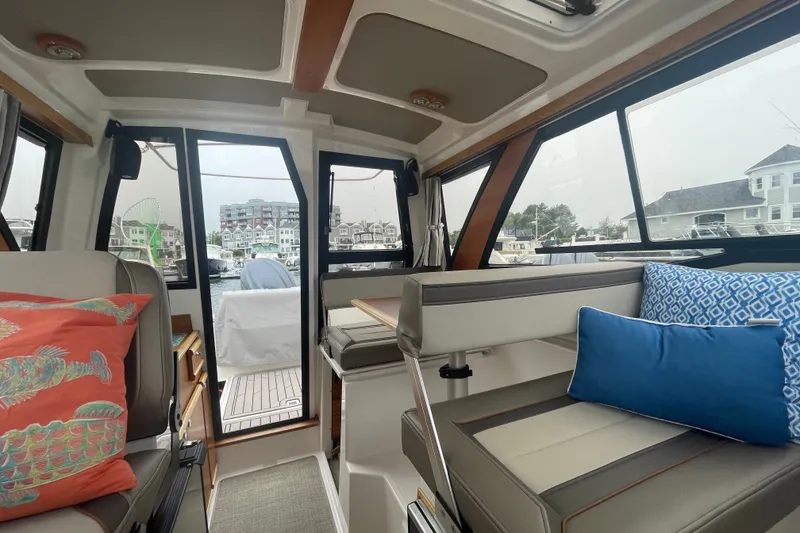 Slide: The Image of Interior of 2024 Cutwater C-248 Coupe boat with stylish seating and cushions. - 16