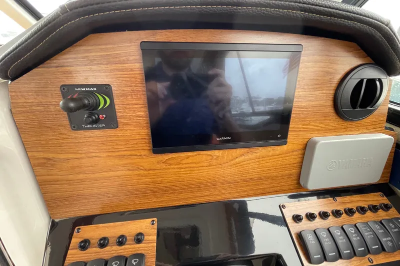 Slide: The Image of 2024 Cutwater C-248 Coupe dashboard with Garmin display and Lewmar thruster control. - 21
