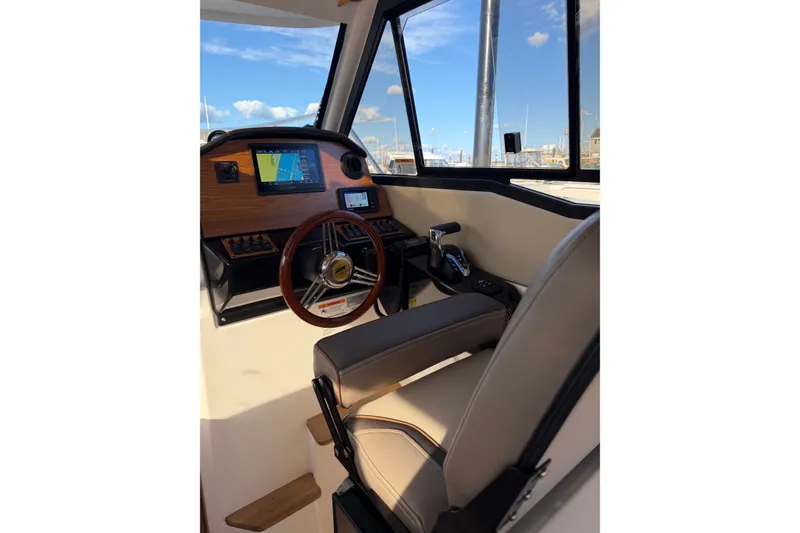 Slide: The Image of 2024 Cutwater C-248 Coupe helm with modern controls and navigation display. - 15