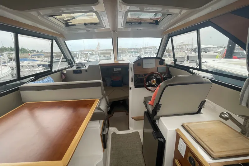 Slide: The Image of Interior of 2024 Cutwater C-248 Coupe boat with helm, seating, and table. - 10