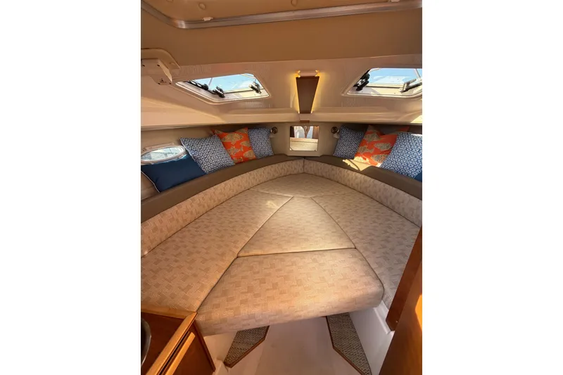 Slide: The Image of 2024 Cutwater C-248 Coupe interior cabin with cushions and skylights. - 19