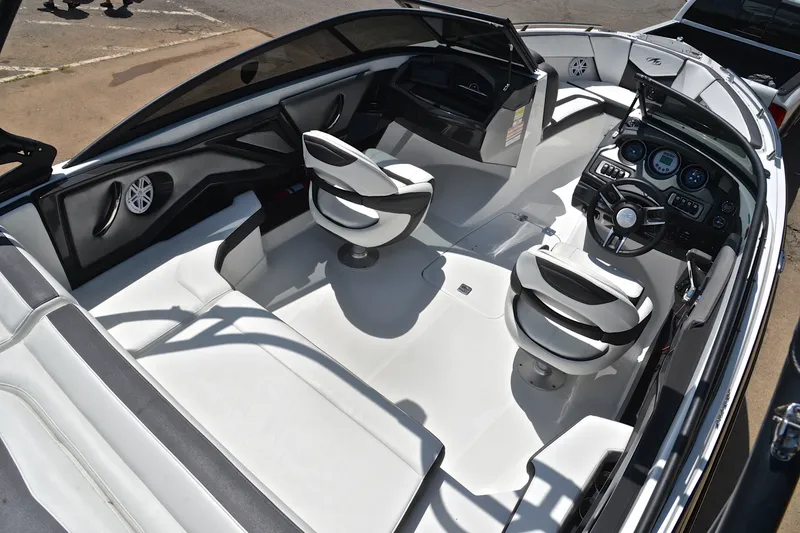 Slide: The Image of Interior of a 2020 Monterey 218 Surf boat, featuring sleek seating and modern dashboard. - 19