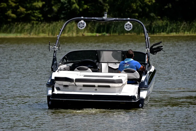 Slide: The Image of 2020 Monterey 218 Surf boat on a lake with a person driving. - 8