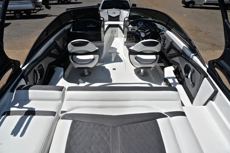 Slide: The Image of Interior of a 2020 Monterey 218 Surf boat with sleek seating and modern dashboard. - 18