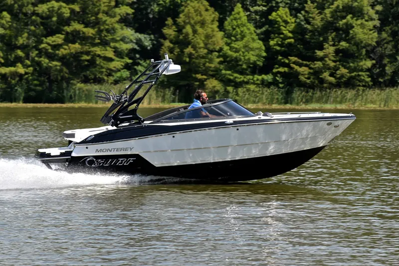 Slide: The Image of 2020 Monterey 218 Surf boat cruising on a lake with lush green trees. - 3