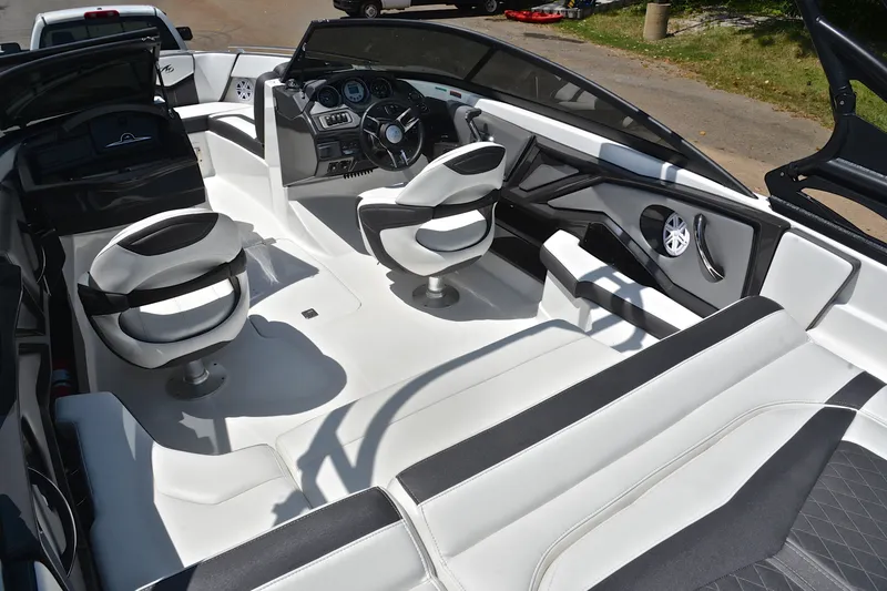 Slide: The Image of Interior of a 2020 Monterey 218 Surf boat with modern seating and dashboard. - 24