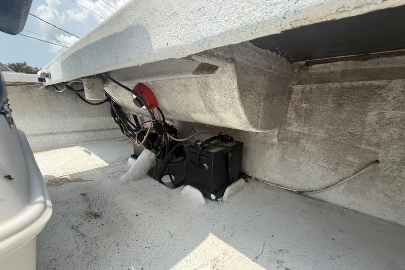 Slide: The Image of Interior view of a 2006 Reno Skiff 23ft boat showing battery and wiring. - 14