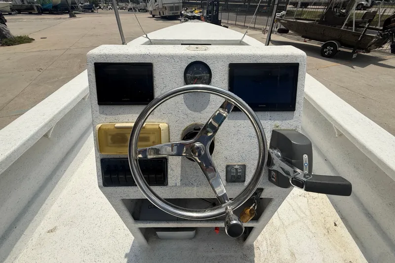 Slide: The Image of Steering console of a 2006 Reno Skiff 23ft boat with navigation equipment. - 12