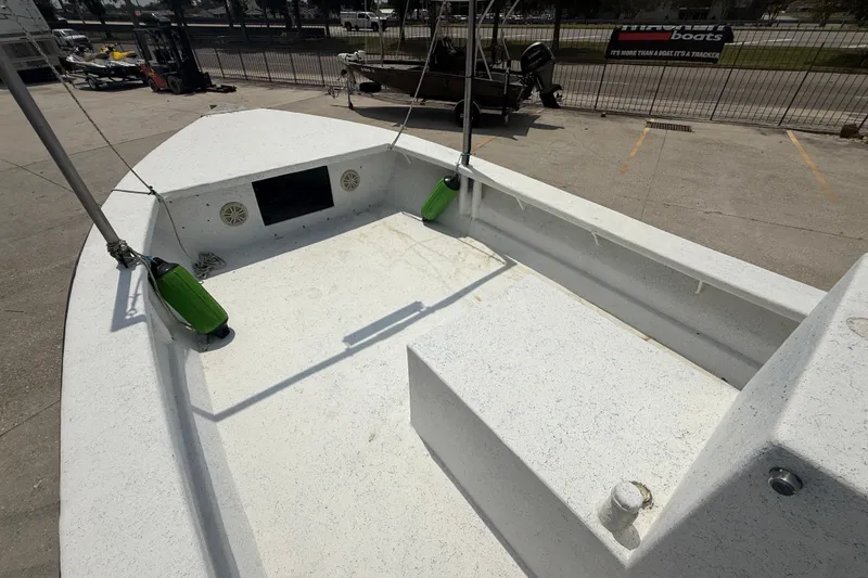 Slide: The Image of 2006 Reno Skiff 23ft boat interior with white deck and green fenders. - 9