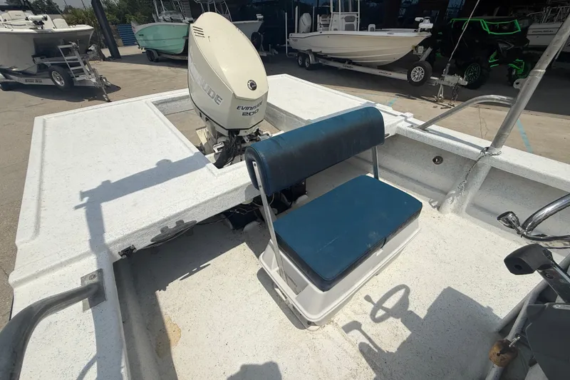 Slide: The Image of 2006 Reno Skiff 23ft boat with Evinrude 200 motor and blue seating. - 11