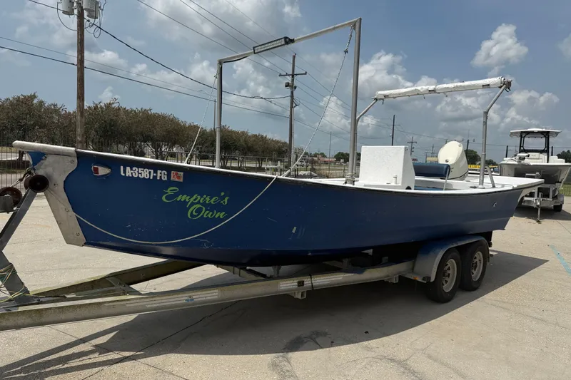 Slide: The Image of 2006 Reno Skiff 23ft boat on trailer, labeled "Empire's Own," parked outdoors. - 3