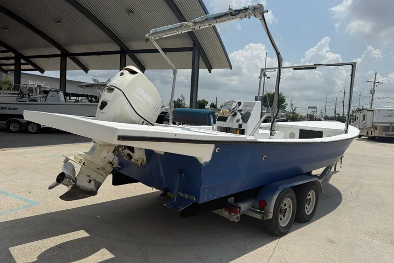 Slide: The Image of 2006 Reno Skiff 23ft boat on trailer, parked outdoors under a cloudy sky. - 6