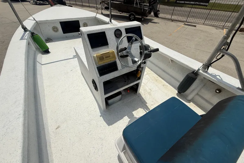 Slide: The Image of 2006 Reno Skiff 23ft boat interior with steering console and seating. - 8