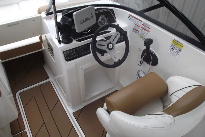 Slide: The Image of 2020 Bayliner DX 2000 boat cockpit with Garmin navigation and brown seating. - 6