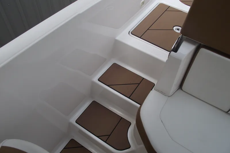 Slide: The Image of Interior view of 2020 Bayliner DX 2000 boat with brown and white seating. - 9