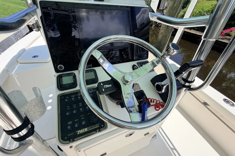 Slide: The Image of Steering console of a 2013 Pathfinder 2300 HPS boat with navigation equipment. - 40