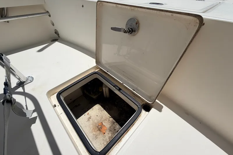 Slide: The Image of Open storage compartment on a 2015 Pathfinder 2300 HPS boat, showing interior details. - 26