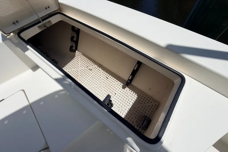 Slide: The Image of Open storage compartment on 2013 Pathfinder 2300 HPS boat, showcasing interior space. - 77
