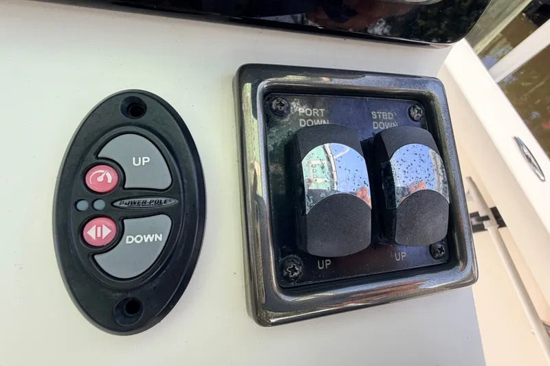 Slide: The Image of Control panel of a 2013 Pathfinder 2300 HPS boat with Power-Pole switches. - 47