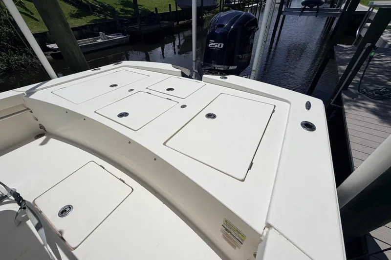 Slide: The Image of 2015 Pathfinder 2300 HPS boat with Yamaha 250 engine, docked by the water. - 12