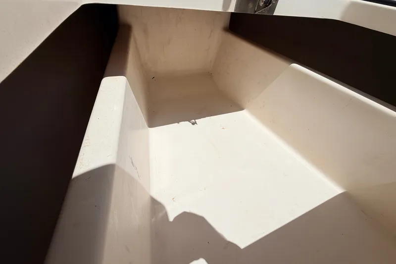 Slide: The Image of Interior view of a 2013 Pathfinder 2300 HPS boat, showcasing clean storage space. - 84