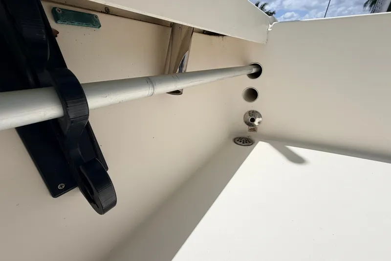 Slide: The Image of Interior view of a 2015 Pathfinder 2300 HPS boat, featuring rod holders and drainage system. - 14