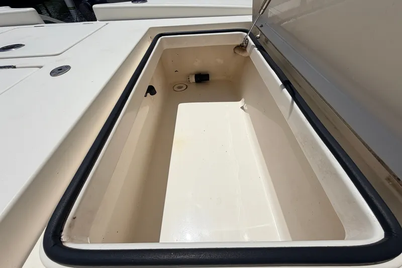 Slide: The Image of Open storage compartment on a 2015 Pathfinder 2300 HPS boat, showcasing interior space. - 24