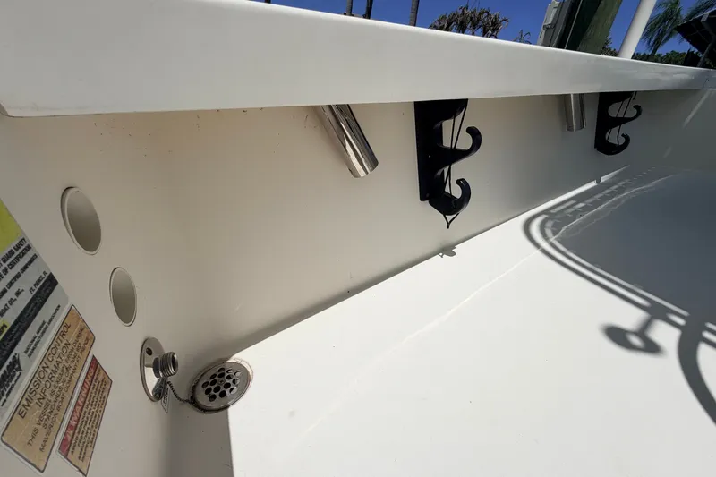 Slide: The Image of Interior view of a 2013 Pathfinder 2300 HPS boat, featuring rod holders and drainage system. - 53