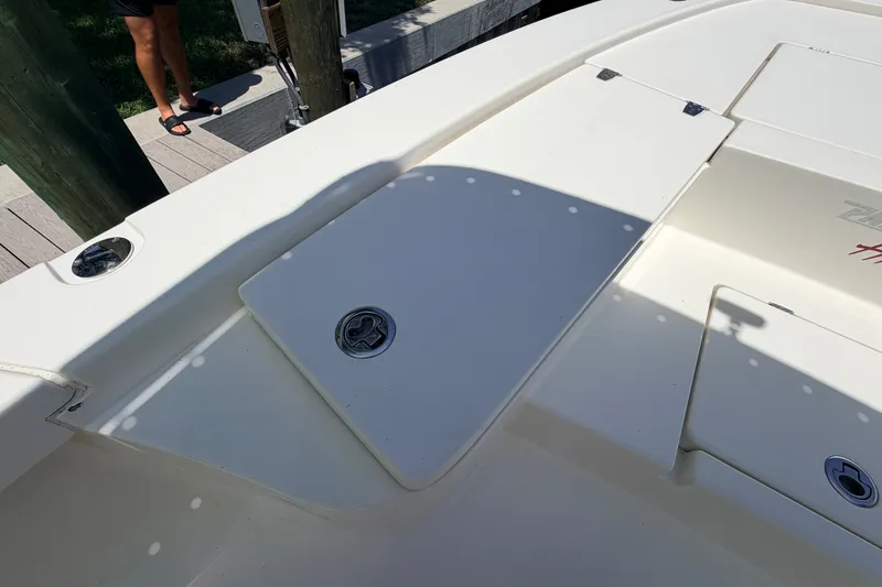Slide: The Image of 2013 Pathfinder 2300 HPS boat deck with storage compartments and dock view. - 71