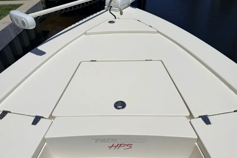 Slide: The Image of 2013 Pathfinder 2300 HPS boat deck with storage compartments and trolling motor. - 82