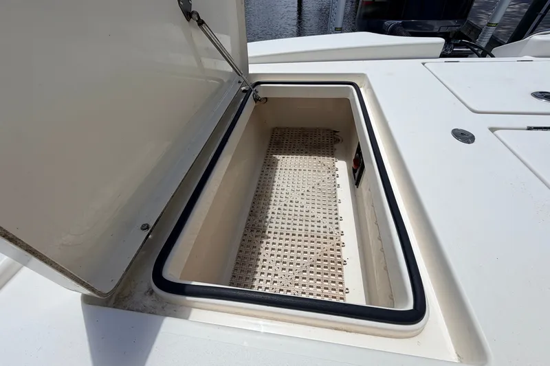 Slide: The Image of Open storage compartment on a 2015 Pathfinder 2300 HPS boat, showcasing interior space. - 18