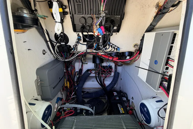 Slide: The Image of Electrical components inside a 2013 Pathfinder 2300 HPS boat, featuring wiring and battery setup. - 59