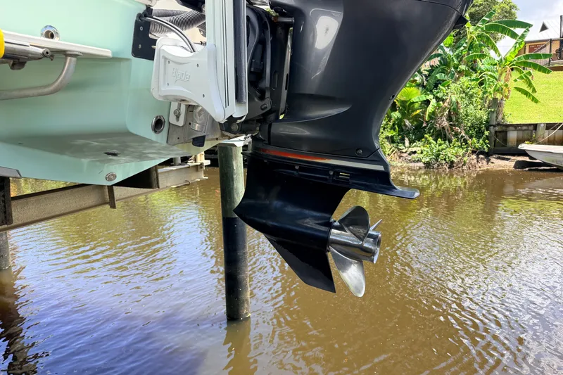 Slide: The Image of Outboard motor of a 2015 Pathfinder 2300 HPS boat above water. - 5