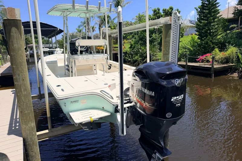 Slide: The Image of 2015 Pathfinder 2300 HPS boat with Yamaha 250 engine docked by lush greenery. - 3