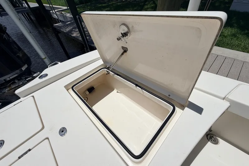 Slide: The Image of Open storage compartment on a 2015 Pathfinder 2300 HPS boat, dockside view. - 23
