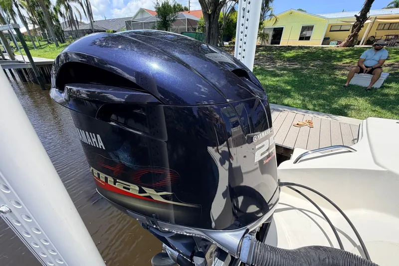 Slide: The Image of Yamaha 250 VMAX outboard motor on a 2015 Pathfinder 2300 HPS boat by a dock. - 10