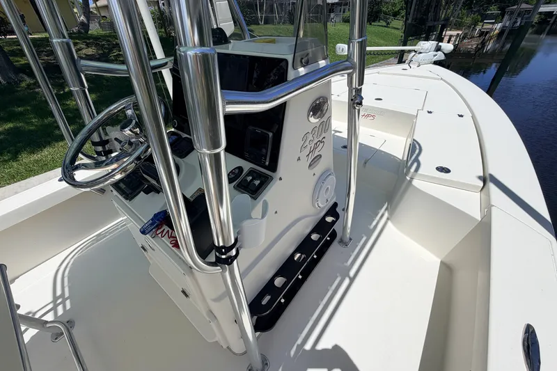 Slide: The Image of 2013 Pathfinder 2300 HPS boat interior with steering console and rod holders. - 52