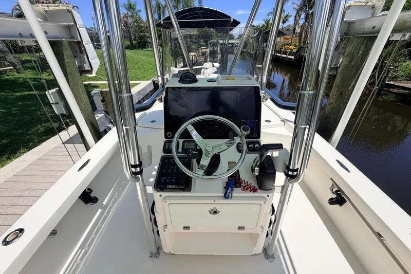 Slide: The Image of 2015 Pathfinder 2300 HPS boat console with steering wheel and navigation equipment. - 33