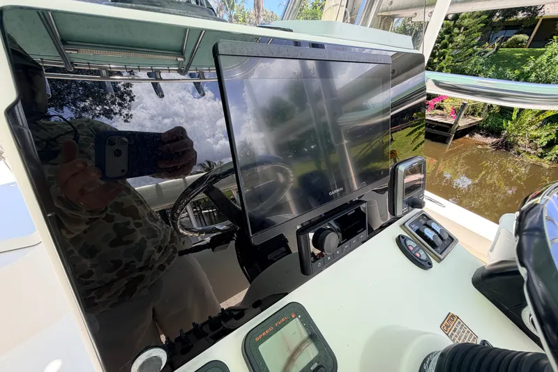 Slide: The Image of Console of a 2013 Pathfinder 2300 HPS boat with Garmin navigation system. - 43