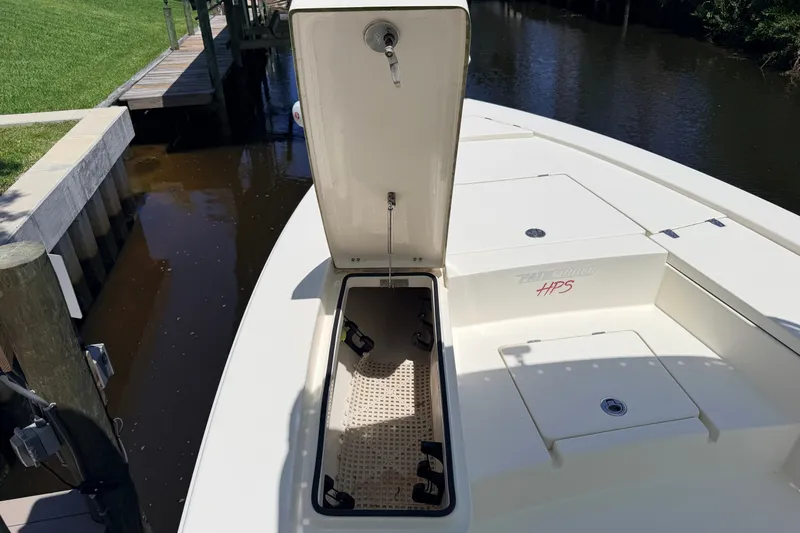 Slide: The Image of 2013 Pathfinder 2300 HPS boat with open storage compartment by a dock. - 72