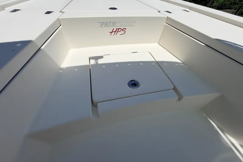 Slide: The Image of 2013 Pathfinder 2300 HPS boat deck with storage compartment and logo. - 79