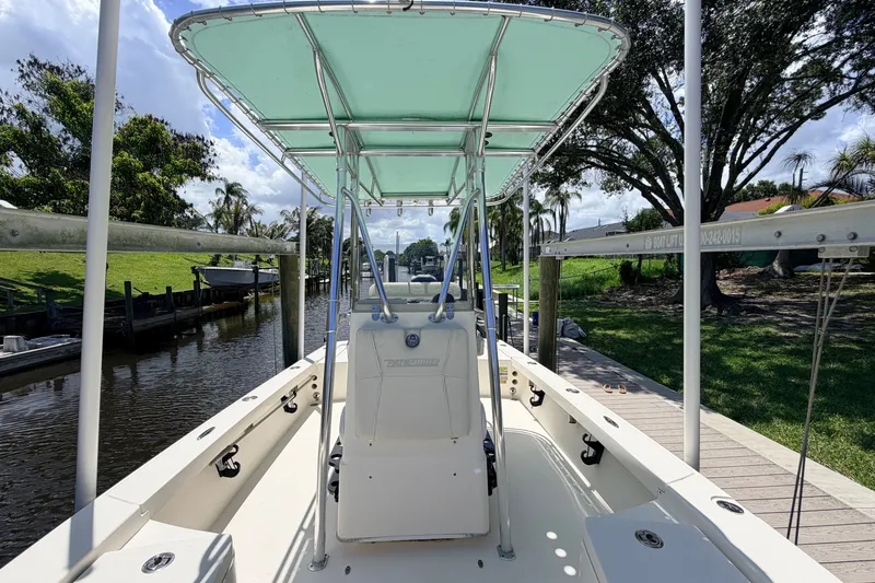 Slide: The Image of 2013 Pathfinder 2300 HPS boat docked by a scenic canal under a clear sky. - 55